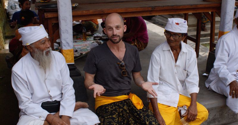 Matt sitting in a monastery courtyard